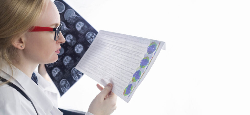 Doctor examining a patient chart, looking at MRI