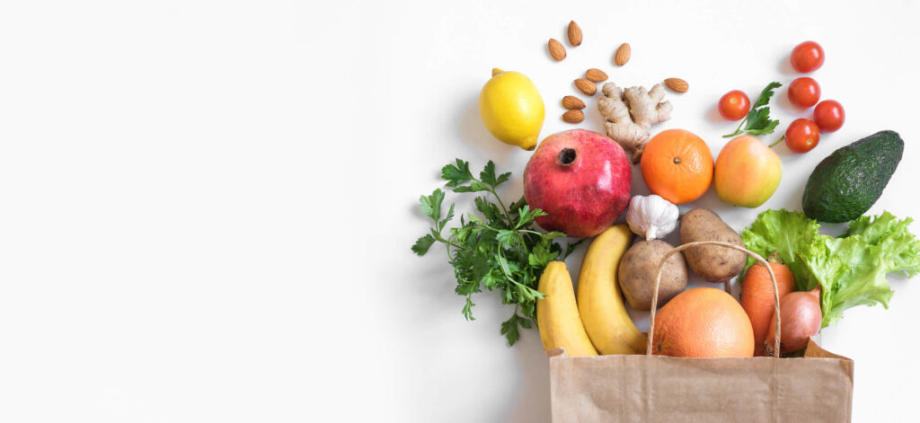 Grocery bag of food spilling out on to table, healthy food options