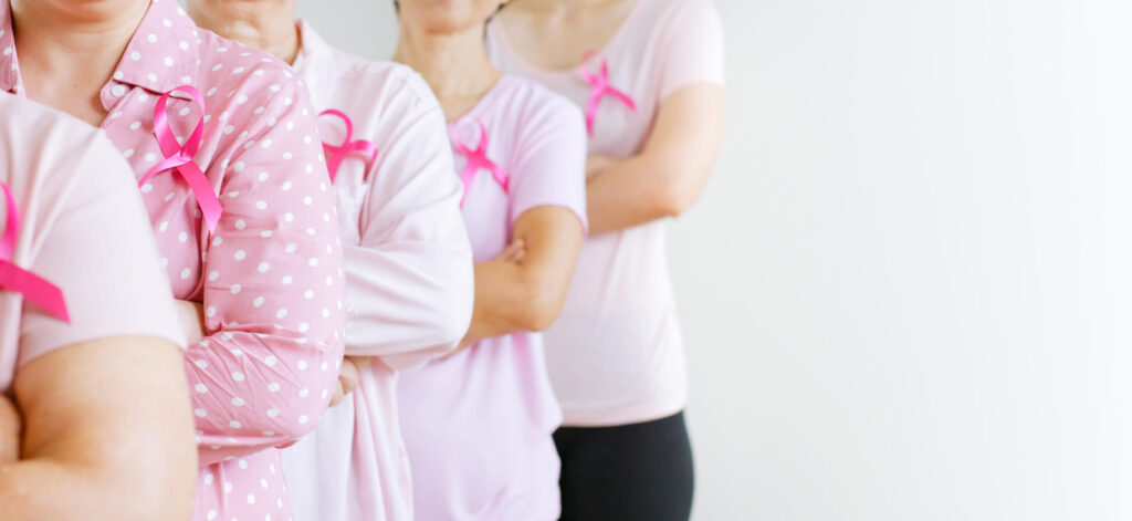Group of women holding breast cancer ribbons