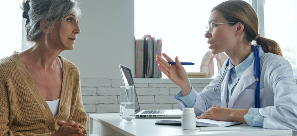 Woman asking her doctor questions at an appointment. Understanding the questions to ask at your first oncology appointment