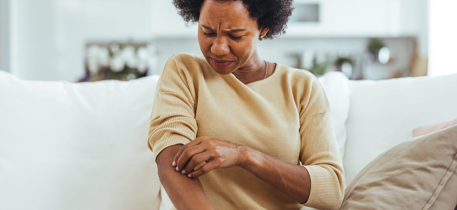 Woman scratching her arm, chronic kidney diseased related itching