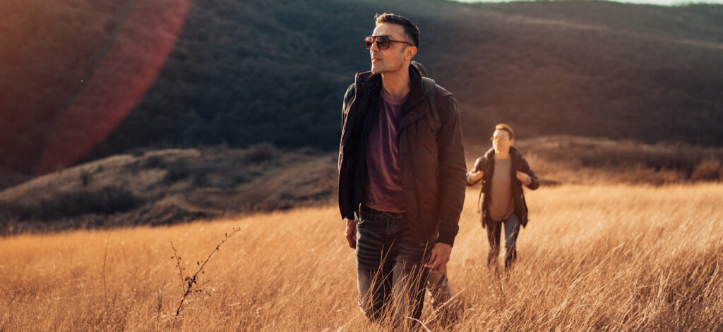 Man hiking with sunglasses, shielded from sun