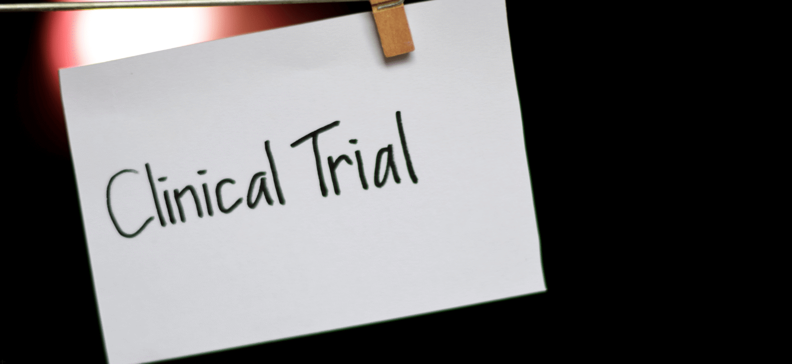 clinical trial written on a note card with black marker