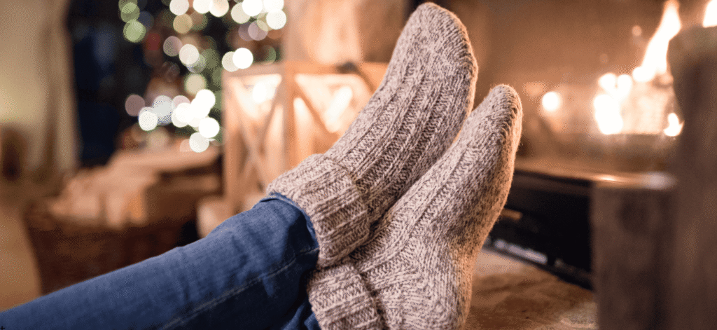 warm, cozy socks, perched near a fireplace. Holiday concept