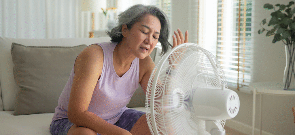woman sitting in front of fan during a hot flash
