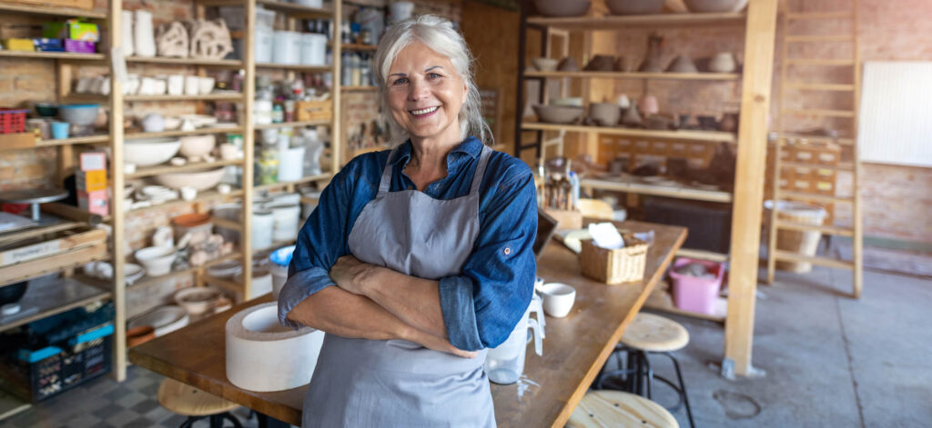 Woman standing in front of a pottery studio, hobbies for people with stage 4 and stage 5 CKD