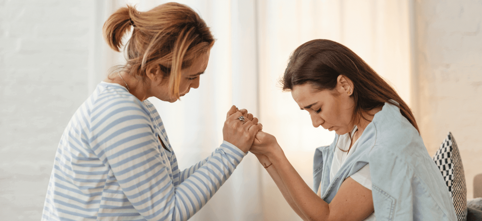 woman holding another woman patient's hands in support