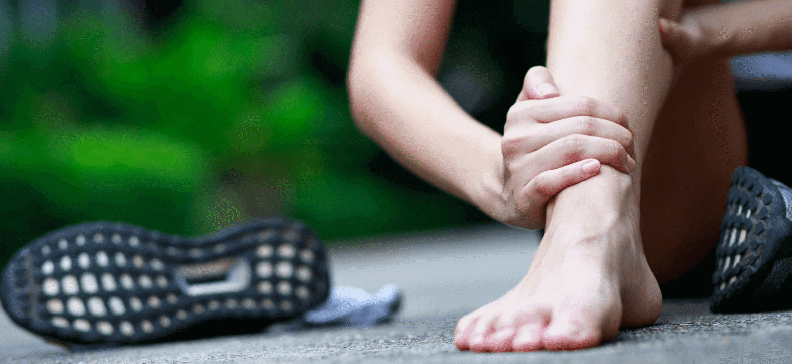 person holding ankle indicating pain