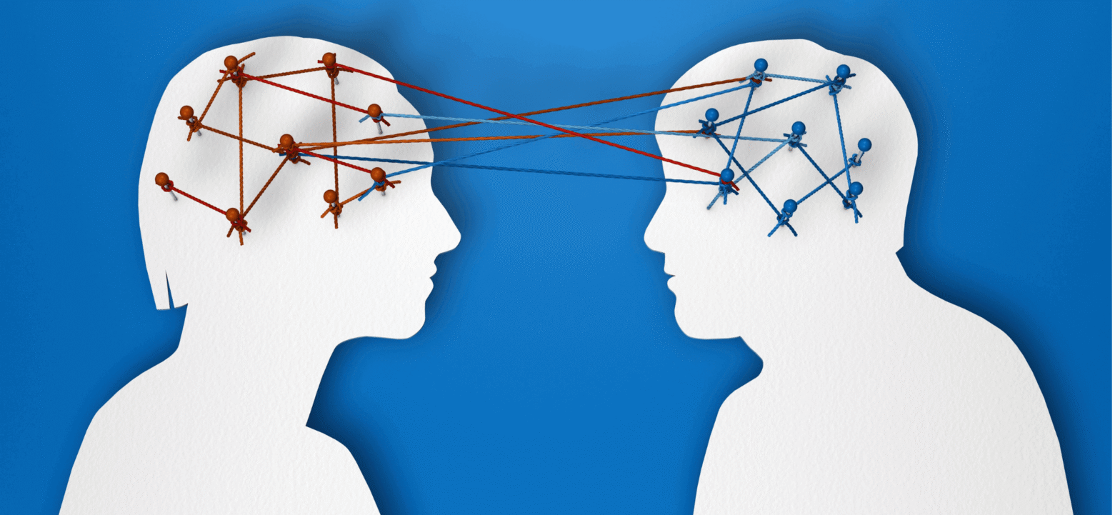 two human outlines with blue and red colored strings mapping brain signals between each other