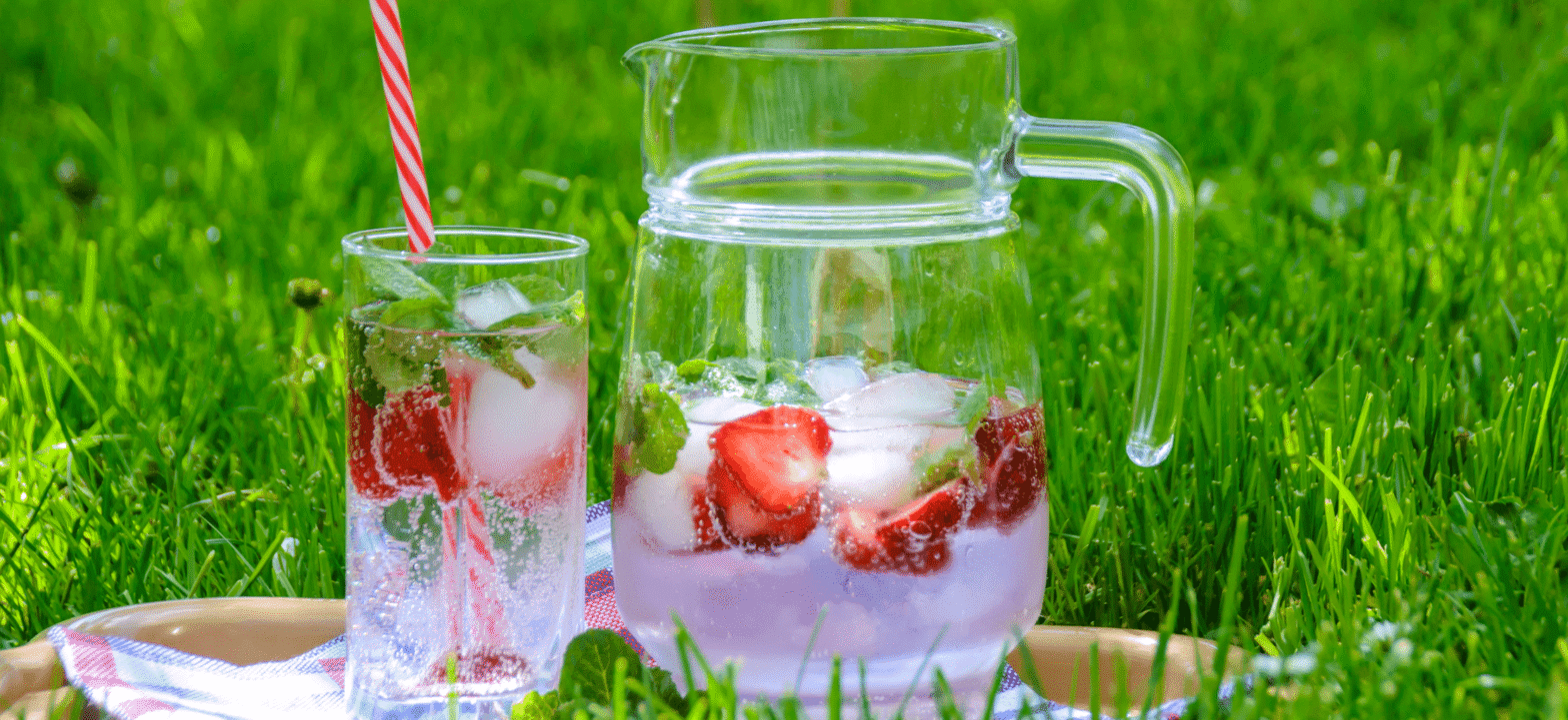glass and pitcher fill with strawberry infused water