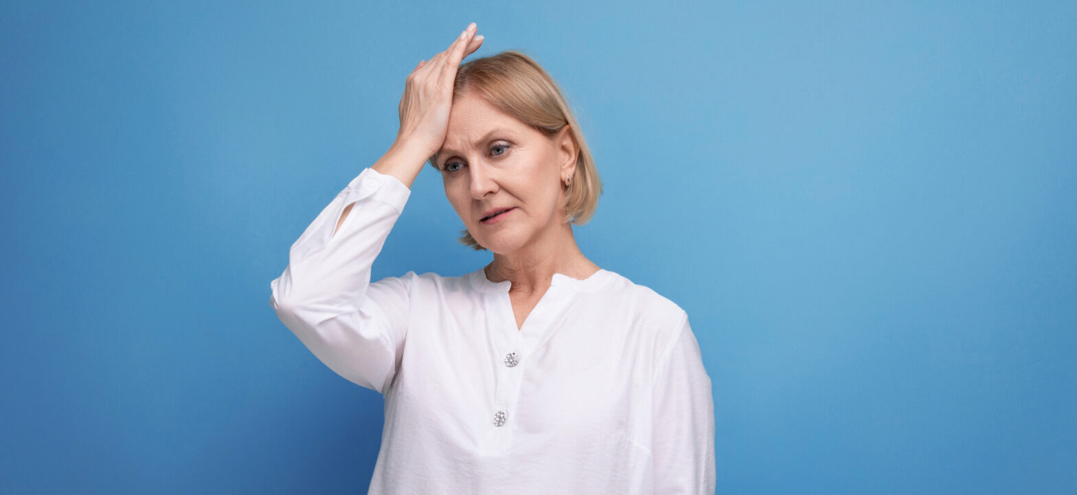 Woman with a headache, menopause and brain health